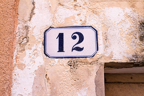 istock Number 12 Street Address Tile On Old Mottled Pinkish Wall 501847854