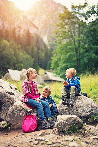 istock Little kids hikers resting in mountains. 501848218