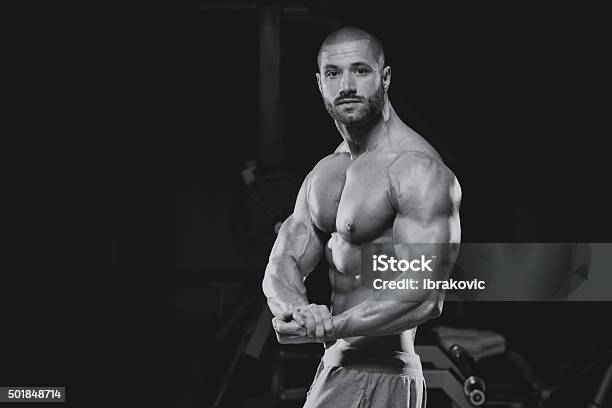 Man In Gym Showing His Well Trained Body Stock Photo - Download Image Now - 2015, Abdominal Muscle, Adult