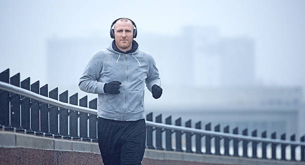istock Middle aged man jogging in the city in winter 501849802