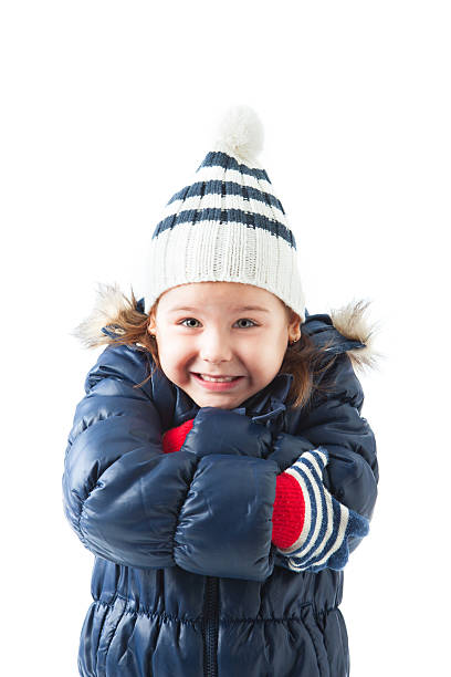 Beautiful little girl wearing winter hat and gloves posing stock photo