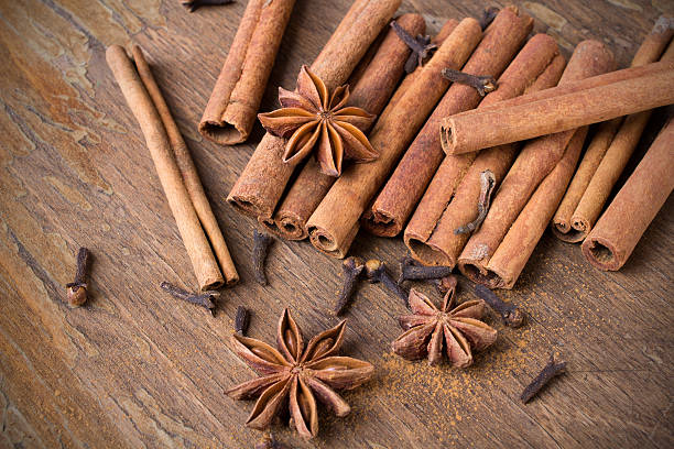 istock cinnamon sticks, star anise and cloves on wooden background 501855010