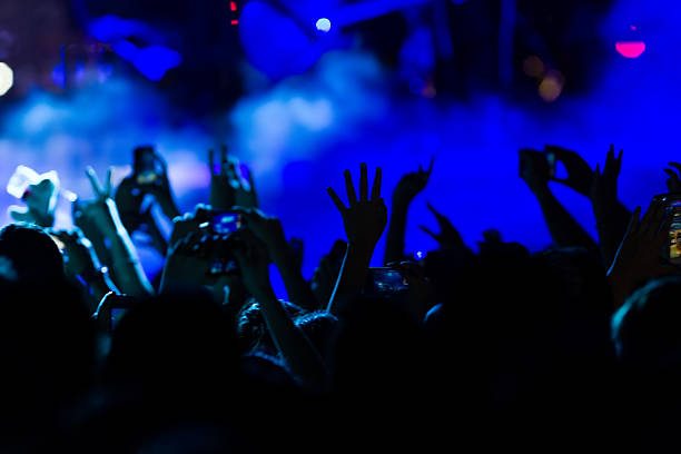 istock People taking photographs with touch smart phone during a music 501858276