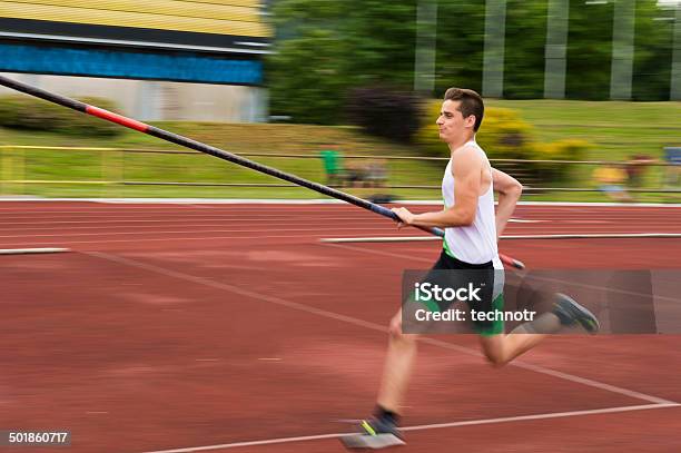 Side View Of Young Male Athlete At Pole Vault Competition Stock Photo - Download Image Now