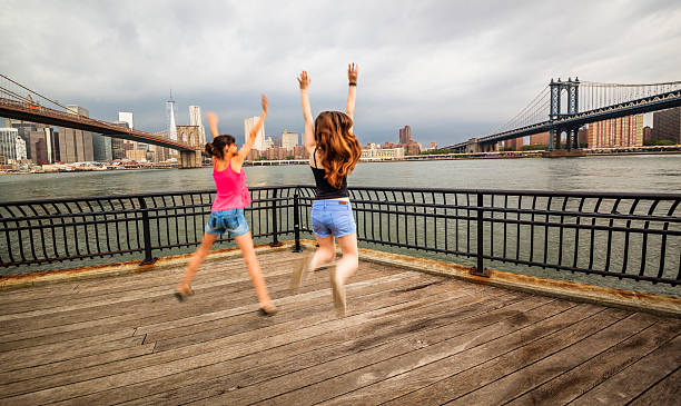 istock Two girls, sisters, jumping at the waterfront 501861073