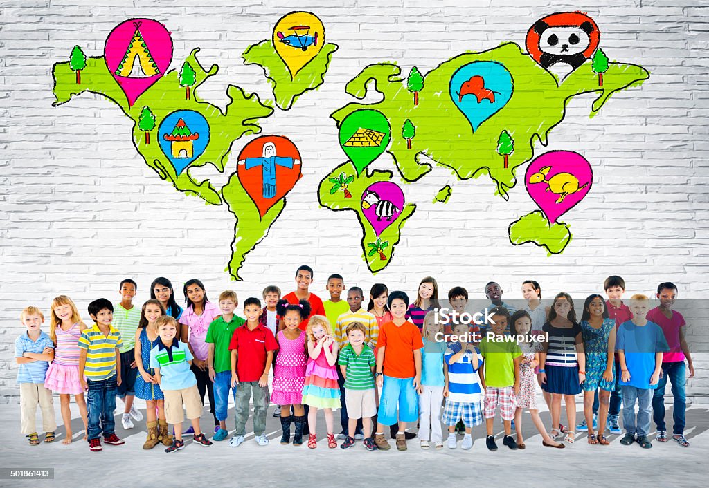 Children Standing In Front Of A Wall Of World Cartography Group of elementary aged children standing in front of a wall of world cartography. African Ethnicity Stock Photo