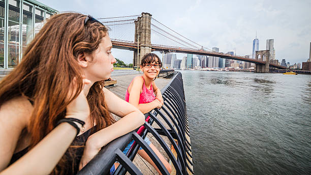 istock Two girls, sisters, looking to Manhattan under thunderstorm 501861453