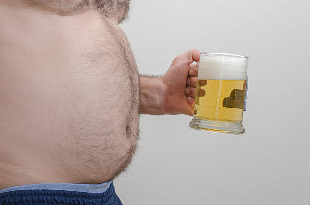 Beer Belly Man with a big gut holding a mug full of beer hairy fat man pictures stock pictures, royalty-free photos & images