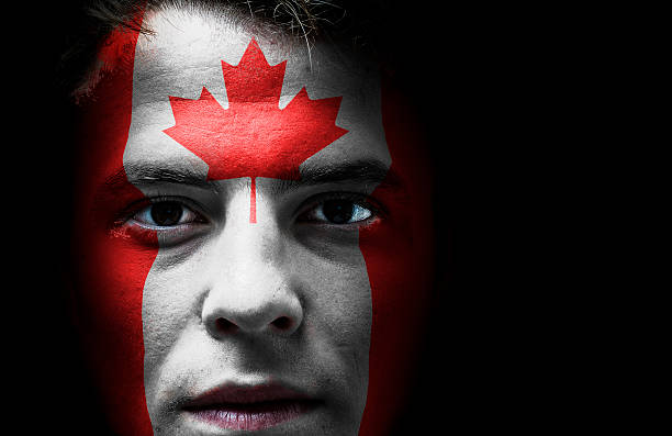 istock Canada, Canadian flaf on face 501863135