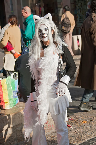 Jerusalem, Israel - March 15, 2006: Portrait of young woman on her face painted like a cat and dressed like a cat. Purim is a Jewish holiday. Purim is the custom of masquerading  in costume and the wearing of masks.