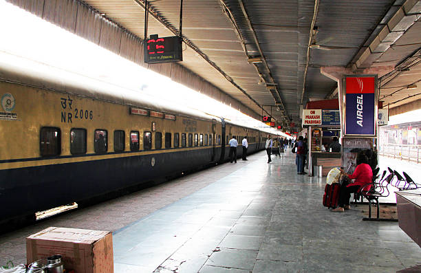 New Delhi, India - March 8, 2011: Passengers board a train at the train station in New Delhi. The railway system is the major means of transportation across India, and is one of the largest systems in the world. With over 115,000 km of track and 7500 stations, India rail services 24 million passengers per day.