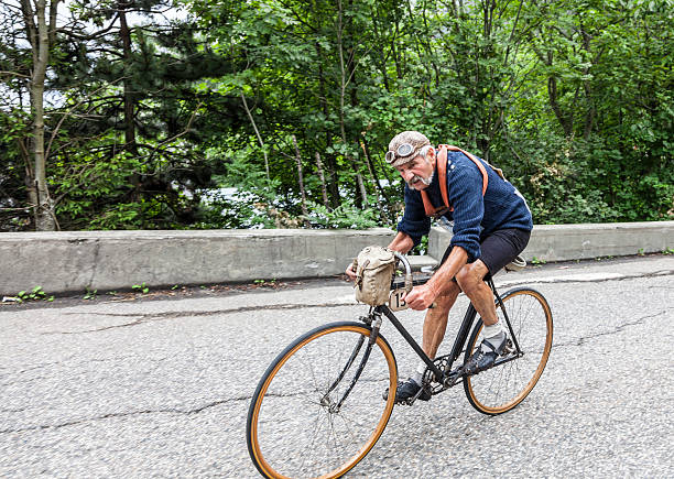 Retro Cycling Alpe-D'Huez,France- July 18, 2013:A man disguised as an old-fahioned cyclist using a retro style bicycle climbing, before the race, the road to Alpe D'Huez,in the stage 18 of the edition 100 of Le Tour de France 2013. tour de france stock pictures, royalty-free photos & images
