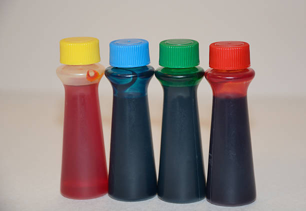 Food Coloring in plastic bottles 4 bottles of food coloring in yellow, blue, green and blue on kitchen counter food coloring stock pictures, royalty-free photos & images