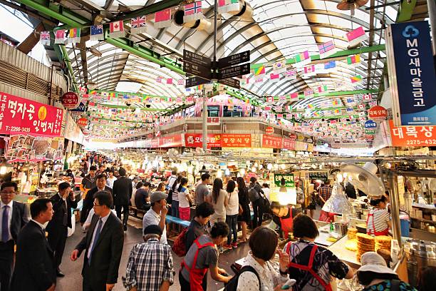 Gwangjang Market The famous Gwangjang Market in Seoul, South Korea. Thousands of people, vendors, and amazing street food. seoul stock pictures, royalty-free photos & images