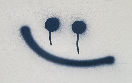 This is a spooky graffiti, smile on the wall.