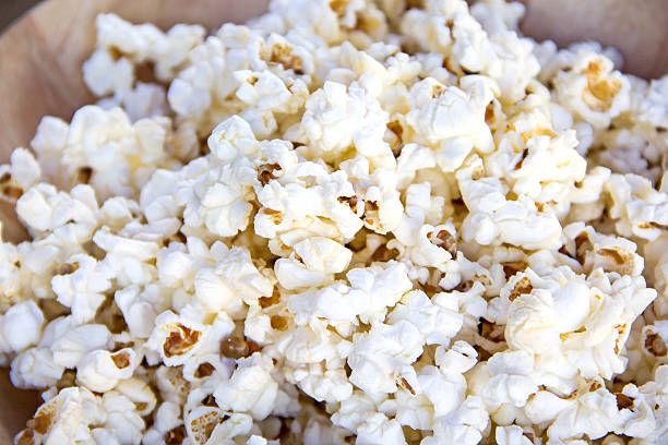 istock Salt popcorn on the wooden table, selective focus 501882386