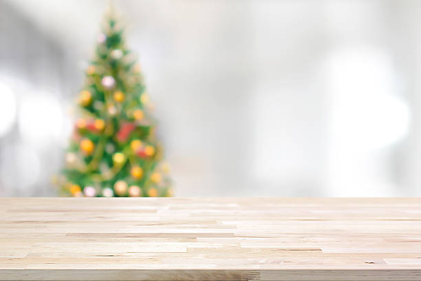 istock Wood table top on blur Christmas tree background 501883160