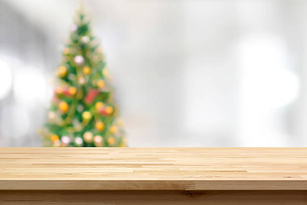 istock Wood table top on blur Christmas tree background 501883206