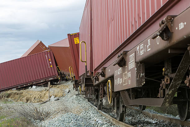 Derailed train coaches at the site of a train accident Thessaloniki, Greece - March 28, 2015: Derailed train coaches at the site of a train accident at the Gefyra community, in northern Greece. The train was carrying electronic equipment . derail stock pictures, royalty-free photos & images