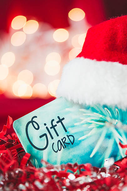istock Christmas gift card with mini Santa hat against holiday background 501883772