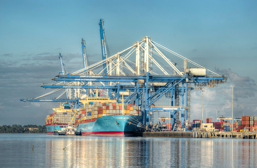 Charleston, SC, US - December 9, 2015: Taken using HDR of the Port of Charleston with cargo ships being loaded on the Cooper River.
