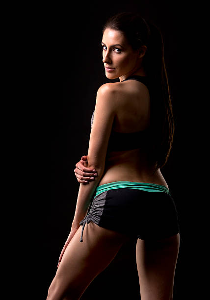 istock fitness woman on black background 501884734