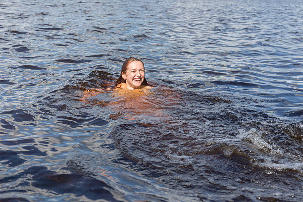 istock cheerful girl in water 501884798