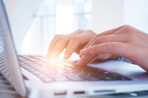 Businesswoman working on desk with laptop