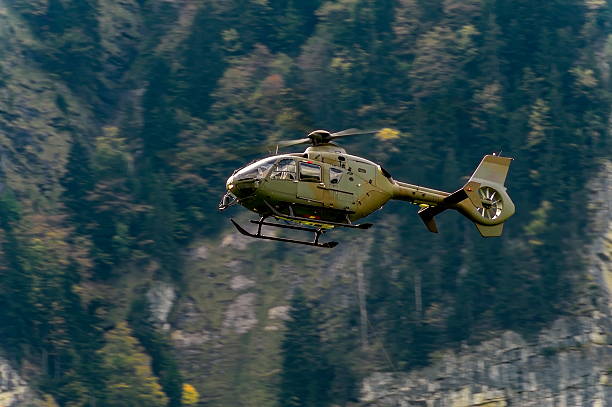 istock helicopter in the sky, alps, europe 501887084