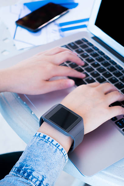 istock Woman working on laptop wearing a smartwatch 501887632
