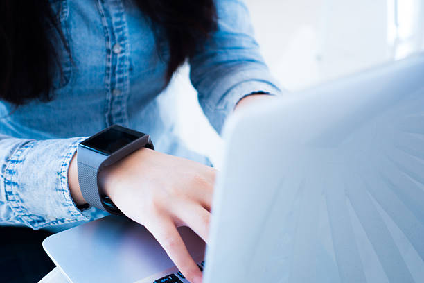 istock Woman working on laptop wearing a smartwatch 501887746