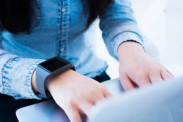 istock Woman working on laptop wearing a smartwatch 501887786