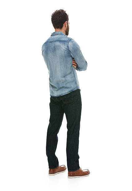 istock Rear view of man standing with arms crossed 501889356