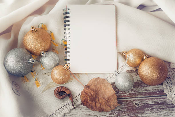 istock notebook with Gold and silver Christmas ball on wood table 501891296