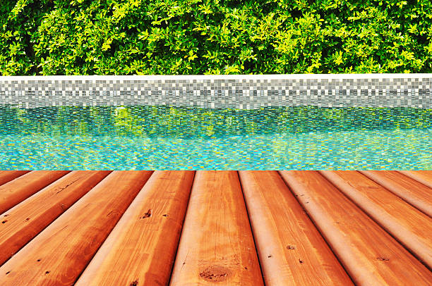 istock Wooden plank ground with swimming pool and tree fence 501894252