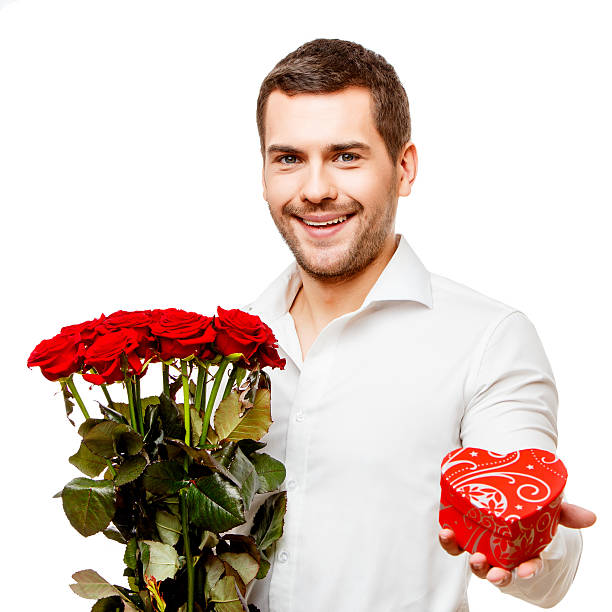 istock Young man carries heart shaped box and flowers 501894714