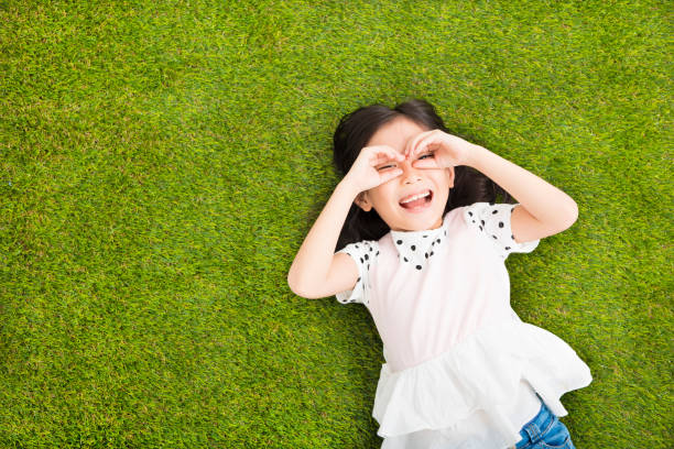 istock happy Little  girl with looking gesture on the grass 501903704