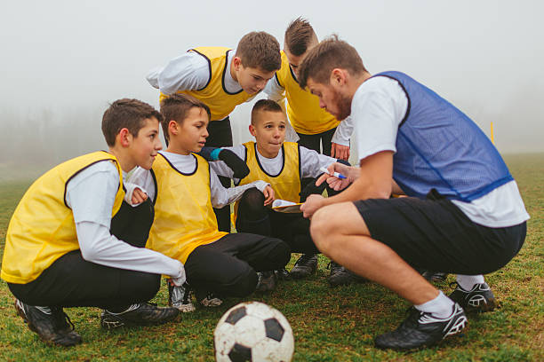 istock Coach Explaining Strategy To His Kids Soccer Team. 501905630