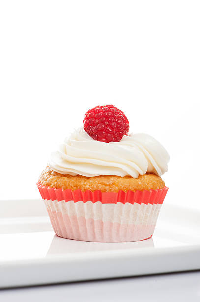 istock Vanilla Cupcakes with cream and a red cherry on top 501905858