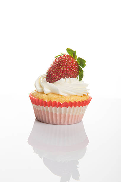 istock Vanilla Cupcakes with cream and a red strawberry  on top 501906344