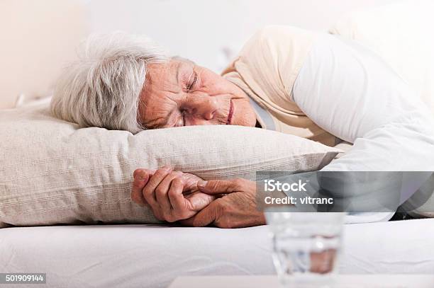 Elderly Woman In Bed Stock Photo - Download Image Now - Sleeping, Senior Adult, Bed - Furniture