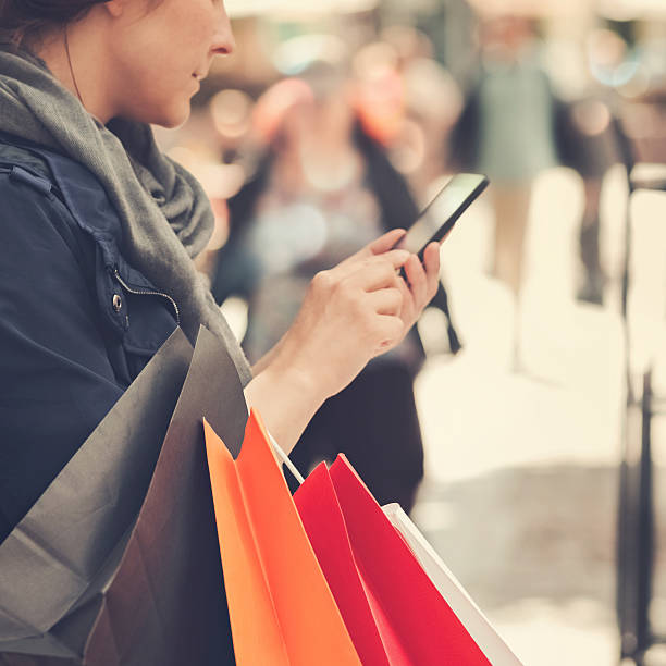 istock Young woman uses a smartphone in an urban environment. 501909502