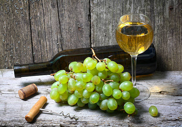 istock wine bottle, grapes and a glass of wine 501909604