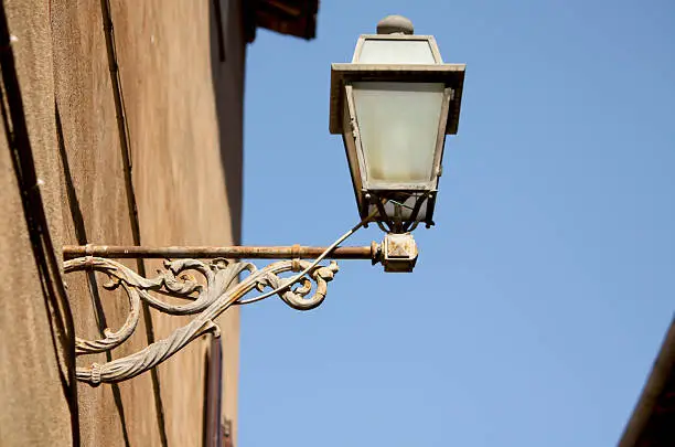 old rugged streetlamp on wall