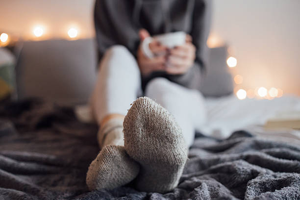 istock Girl drinking hot tea in bed 501912790