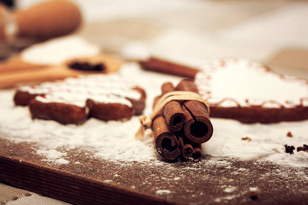 Gingerbread cookies, spices and flour over wooden background