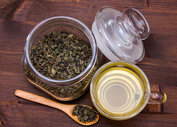 istock Cup of green tea on wood from above 501913200