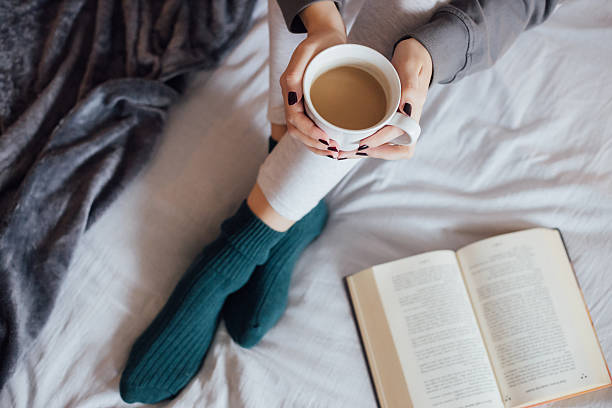 istock Girl drinking hot tea in bed 501913834
