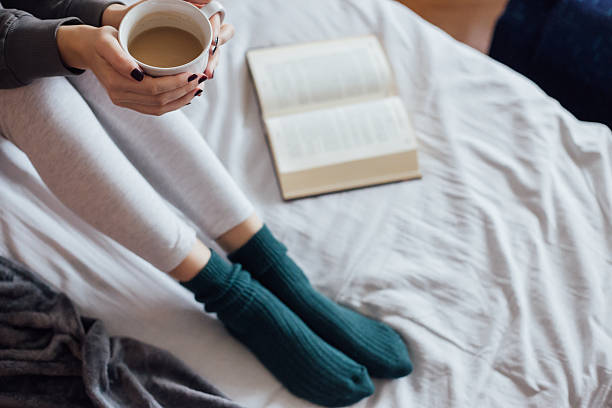 istock Woman on the bed with book and coffee 501914136
