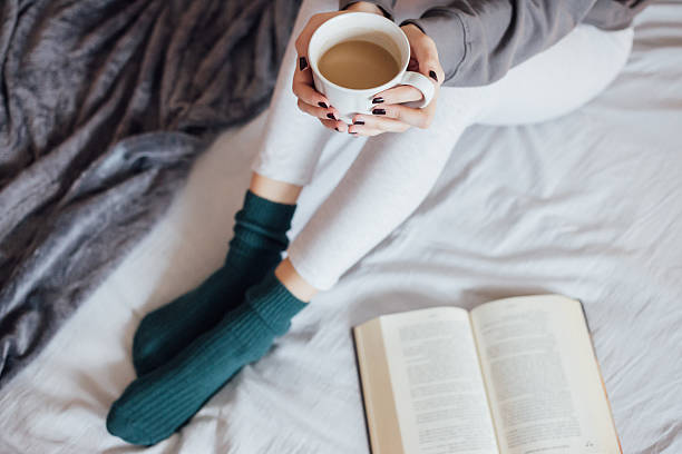 istock Woman on the bed with book and coffee 501914244